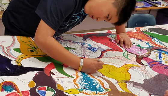 Students work together on an art project.
